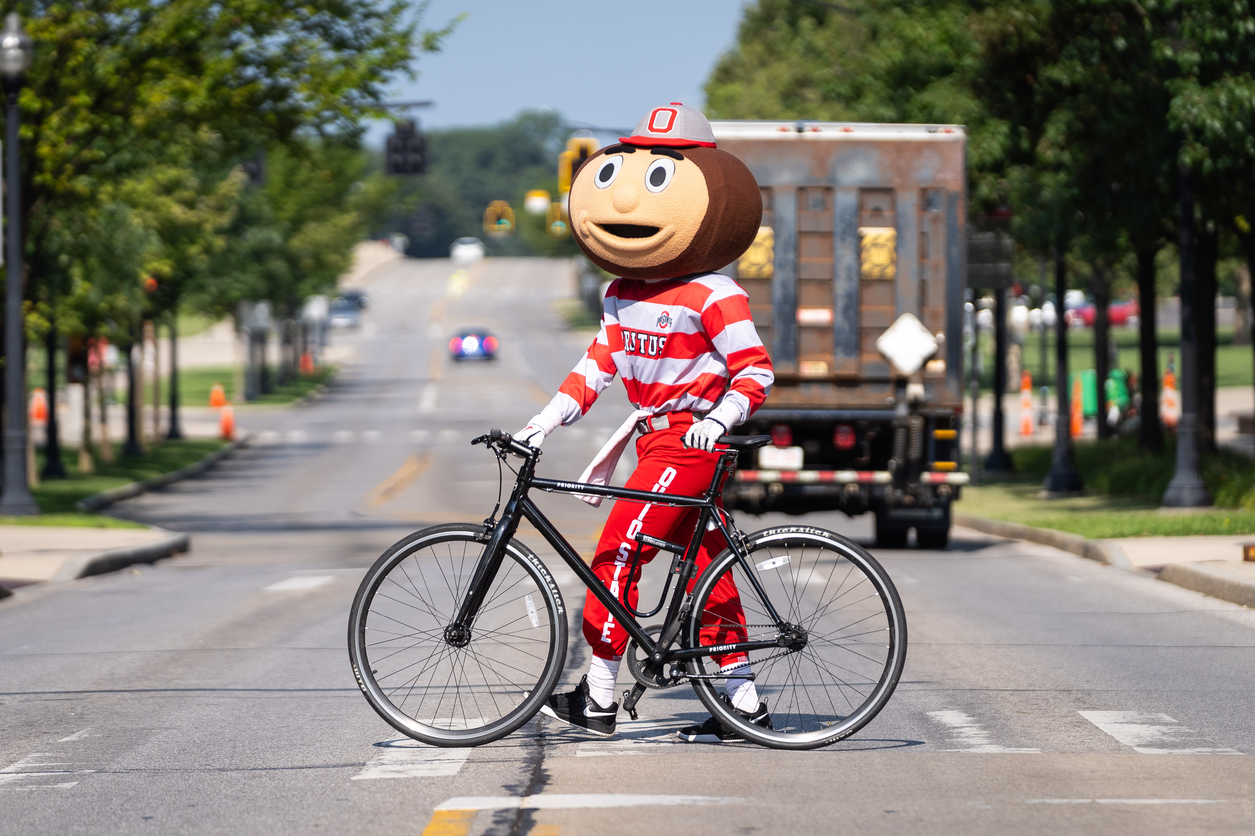 Brutus walking a bike across a street crossing