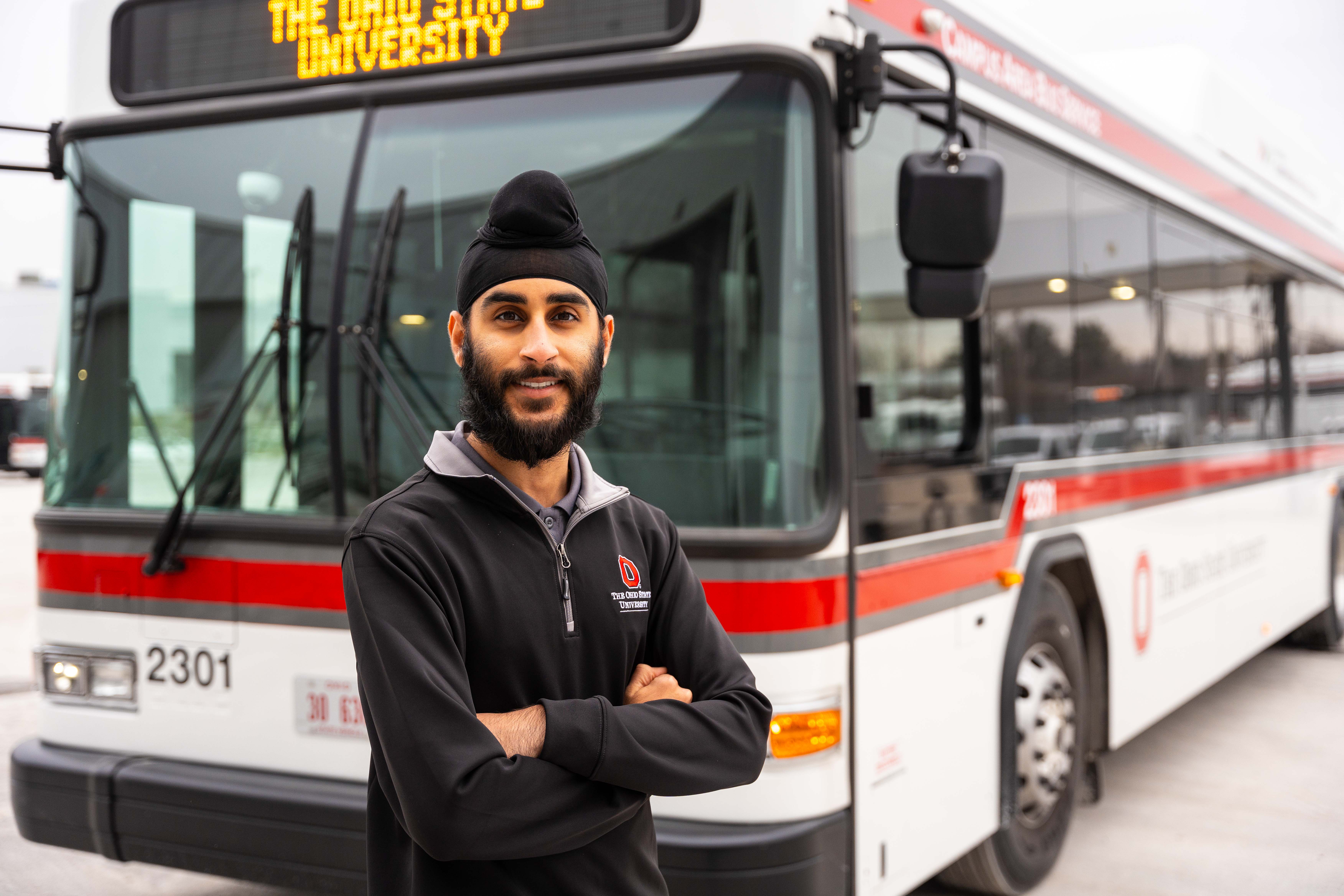 Student CABS driver posing in front of bus