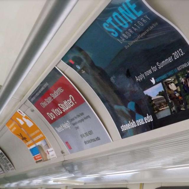 Advertisements along the interior roof of a CABS bus