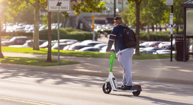 Student riding on a scooter