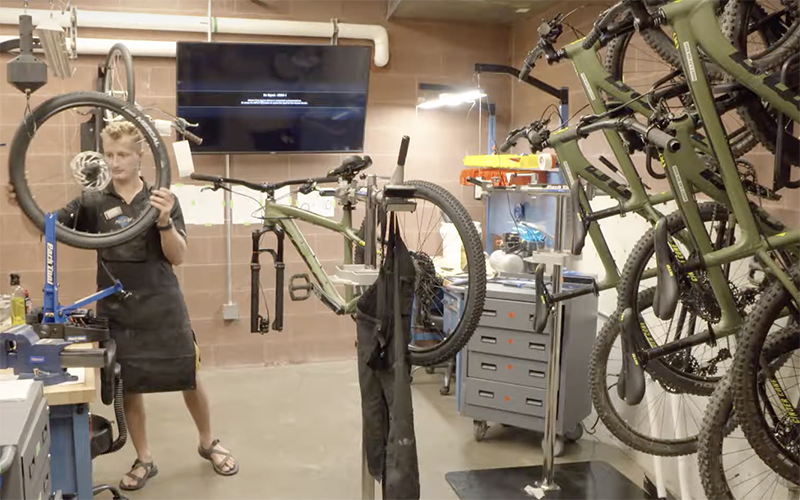 student fixing bicycle in the bicycle shop